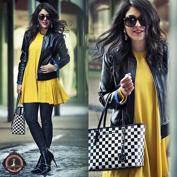 Zipy rocks a bright yellow dress with a leather jacket and a checkered handbag