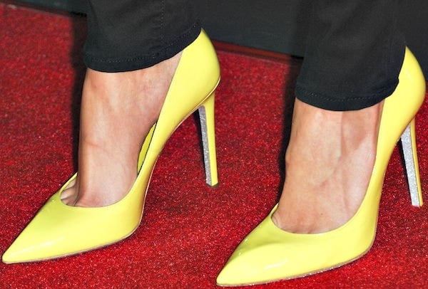 Debby Ryan's bright yellow patent leather pumps from Rene Caovilla