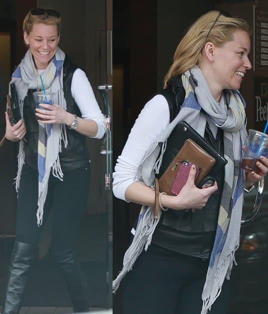Elizabeth Banks opts for a laid-back look with a leather vest, black over-the-knee boots, and a color-blocked scarf while grabbing coffee
