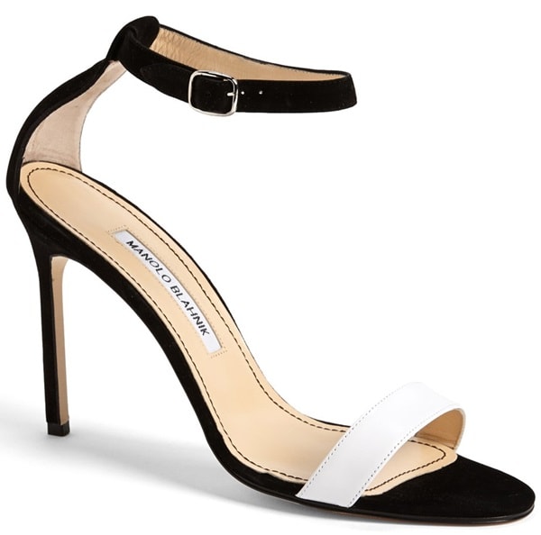 A chic, minimalist two-tone sandal is shaped with an ankle strap and a slender setback heel