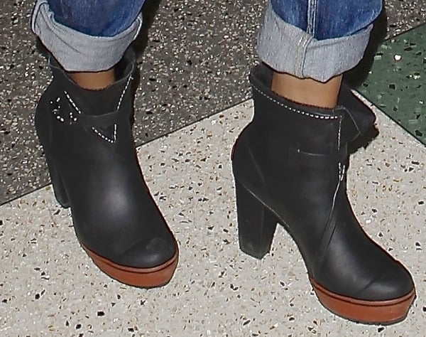 Selena Gomez's chic Sorel rain ankle boots, perfect for stylish and comfortable travel