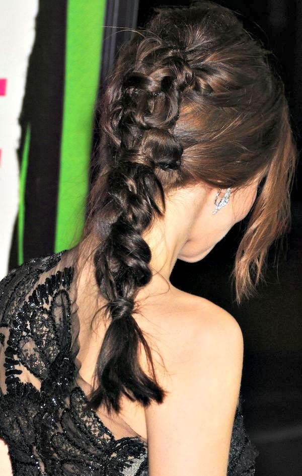 Zoey Deutch's hair was swept to one side and styled in an intricate braid