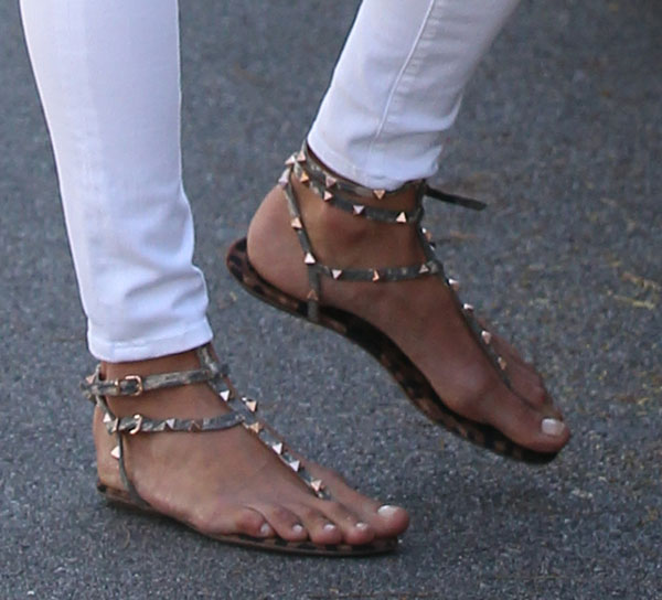 Alessandra Ambrosio completes her casual chic look with Valentino "Rockstud" sandals featuring gold-tone studs and leopard-print insoles