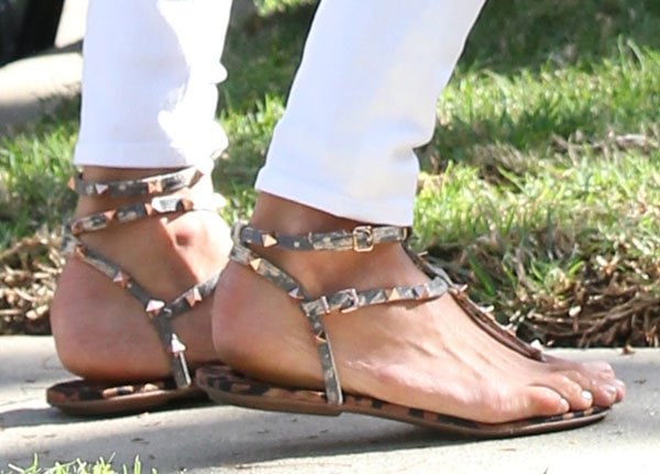 Alessandra Ambrosio completes her look with Valentino "Rockstud" sandals, adding a bold touch to her outfit