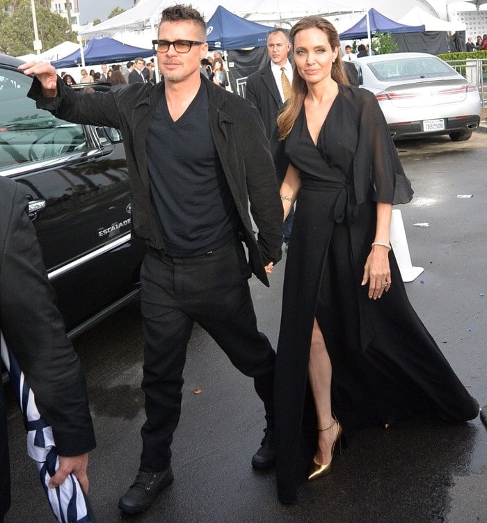 Angelina Jolie looked stunning in a black ruffled wrap gown from her favorite label, Saint Laurent