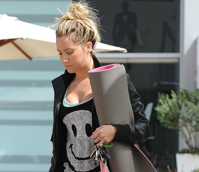 Ashley Tisdale ties her hair up as she heads to a yoga class