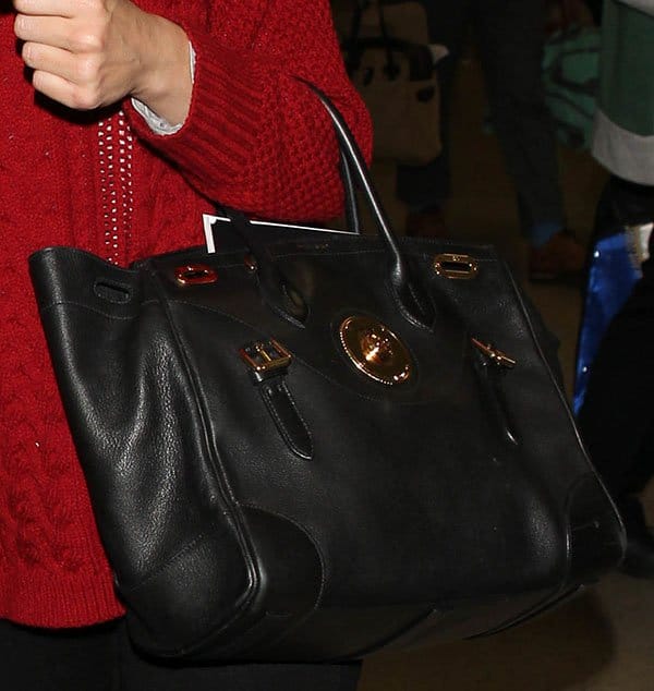 Emmy Rossum’s luxurious Ralph Lauren “Ricky” satchel adds elegance to her casual look