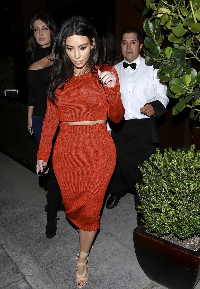 The reality star Kim Kardashian shows off her curves in red dress