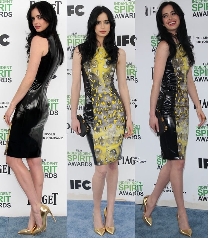 Krysten Ritter wears a yellow-and-black animal print dress on the blue carpet