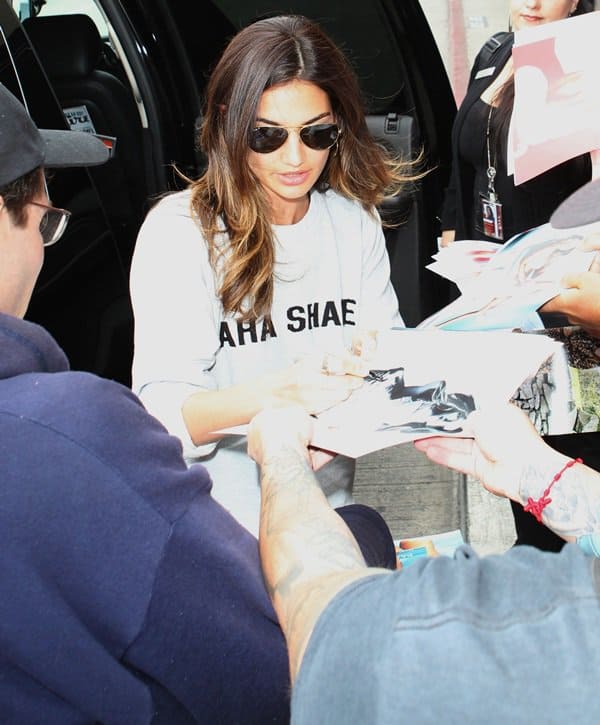 Lily Aldridge wears an Aha Shake Kings of Leon sweatshirt