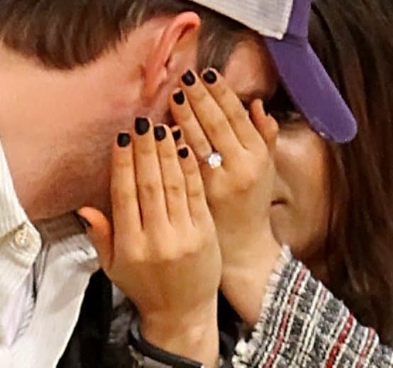 Mila Kunis shows off her 5-carat round-cut solitaire diamond engagement ring encased in a platinum band