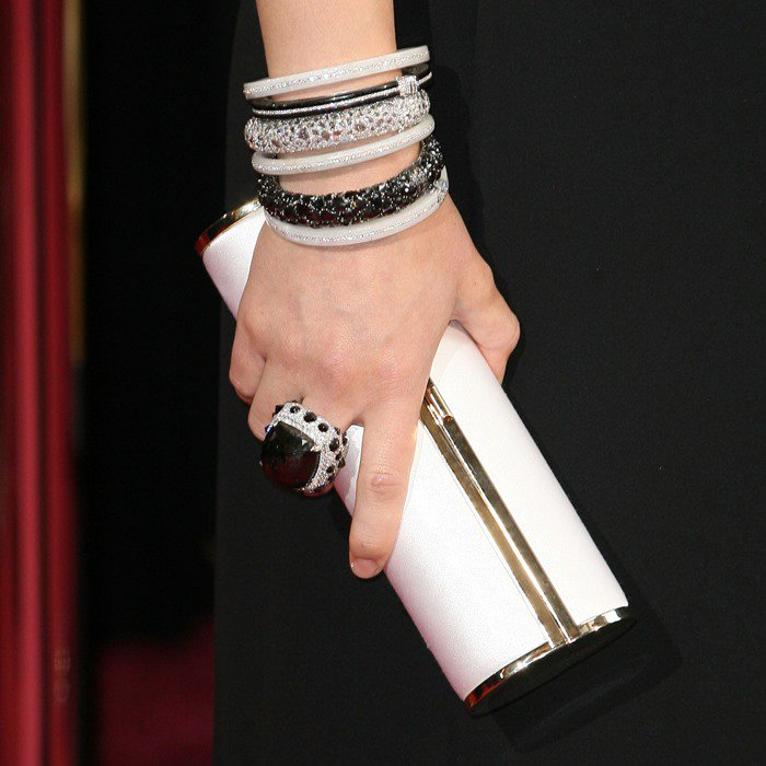 Olivia Wilde carries a white Jimmy Choo clutch on the red carpet of the Academy Awards
