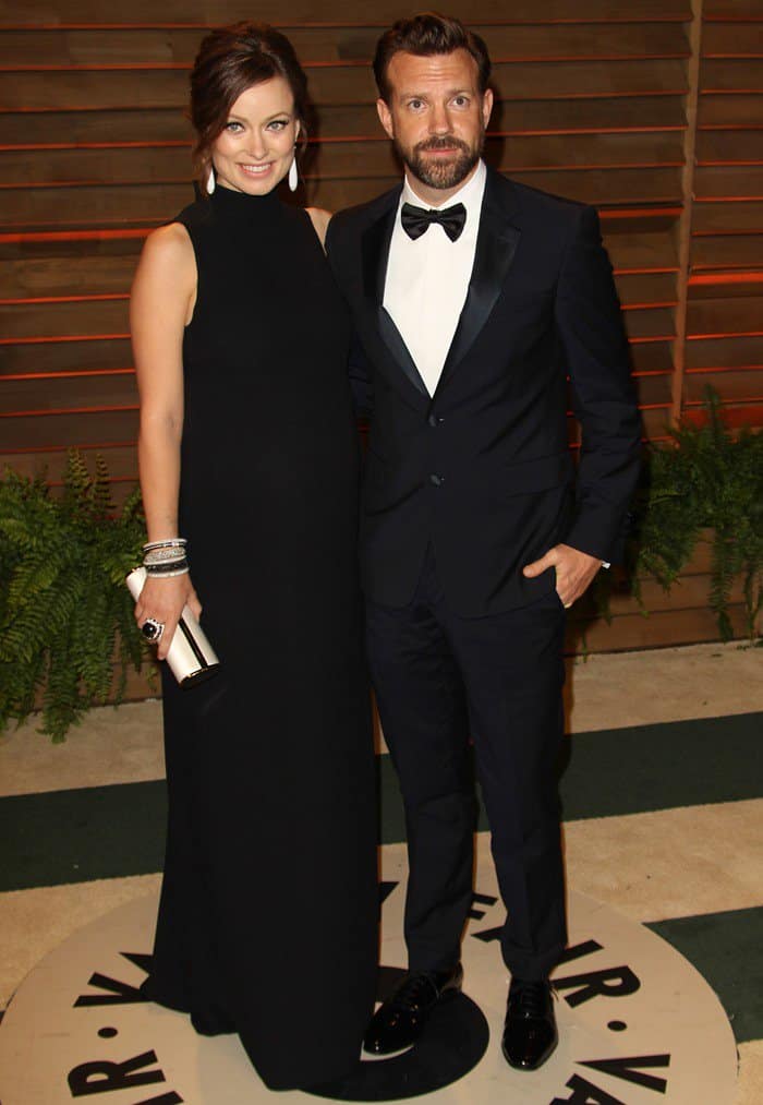Olivia Wilde wears a floor-length Valentino dress and Jason Sudeikis wears a Prada tuxedo to the annual Academy Awards