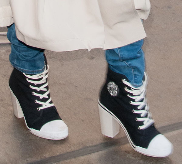 A close-up of Rita Ora's bold footwear choice—DKNY for Opening Ceremony high-heel sneakers—blending sporty high-tops with a chic block heel for an edgy streetwear twist