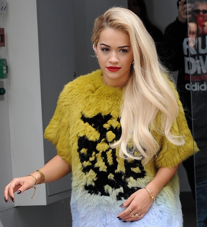 Rita Ora wears her blonde hair down and swept over one shoulder as she arrives at Global Radio