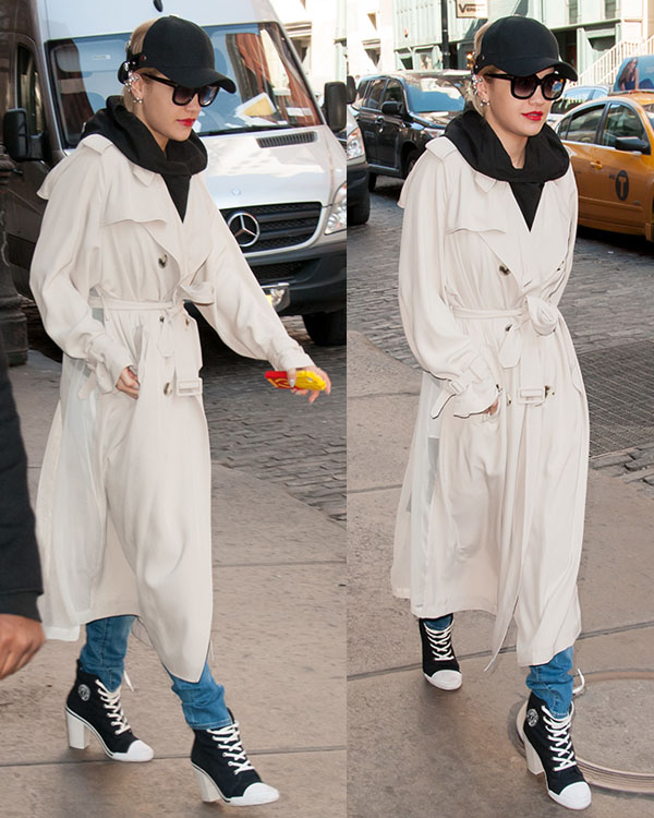 Rita Ora steps out in New York City wearing a chic belted trench coat, casual jeans, and bold DKNY for Opening Ceremony high-heel sneakers for an effortlessly stylish streetwear look