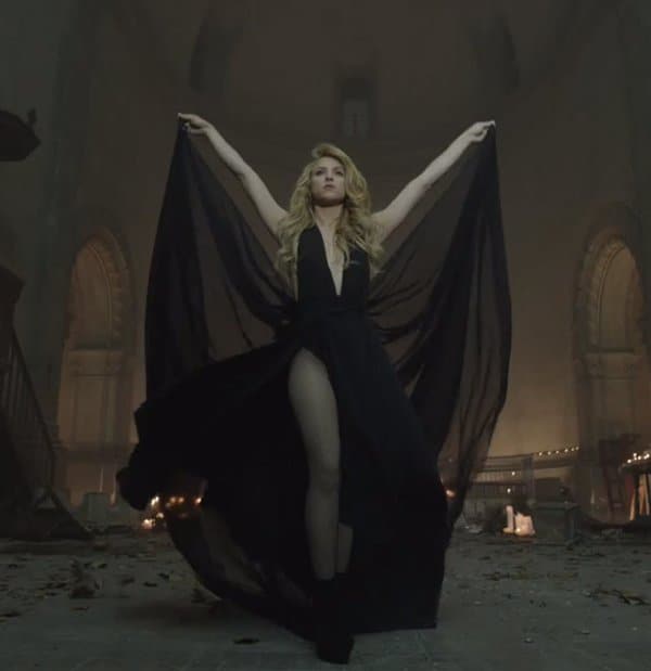 Shakira exudes power and elegance in a dramatic black gown with flowing sheer panels during her "Empire" music video
