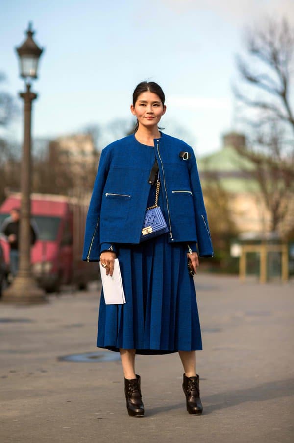 Stacie Chen in a bold-colored pleated midi skirt and boxy coat