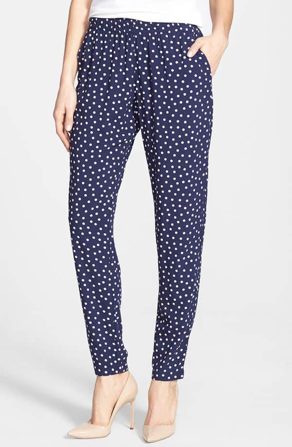 White dots playfully pattern flowy pants designed with an easy elastic waist and pleated for comfortable fullness through the hips and thighs before tapering to a slim end