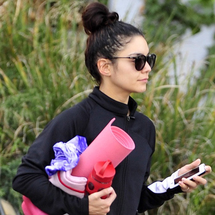 Vanessa Hudgens throws her hair up in a messy bun as she heads to a yoga class