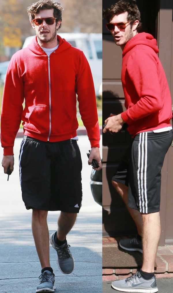 Adam Brody wears gym shorts and a red hoodie while out and about in Los Angeles