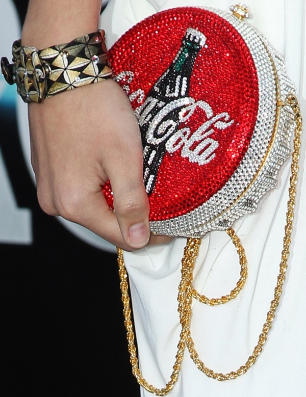 Chelsea Gilligan carries a Coca-Cola-embellished clutch