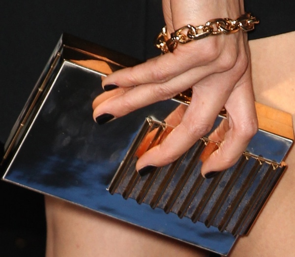 Maggie Q toting a gold clutch