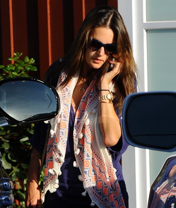 Alessandra Ambrosio wears a blue dress from her fashion line for Planet Blue