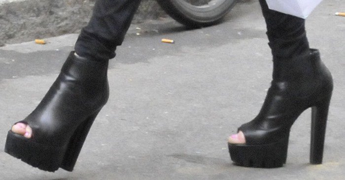 Allegra Versace's feet in peep-toed leather heeled booties