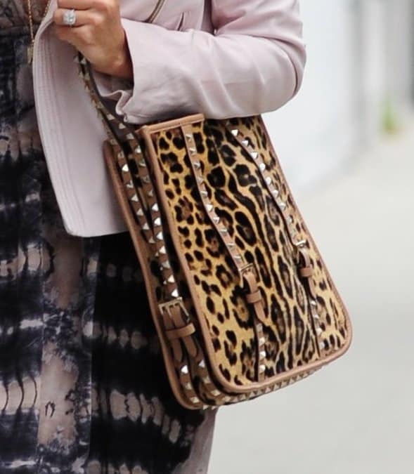 A close-up of Ashley Tisdale's studded leopard-print Valentino bag that clashed with her tie-dye maxi dress