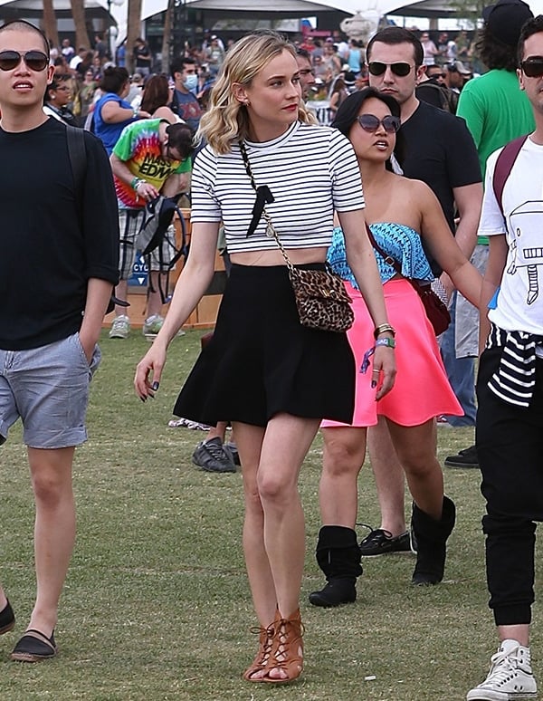 Diane Kruger in a striped crop top with a high-waisted black skirt