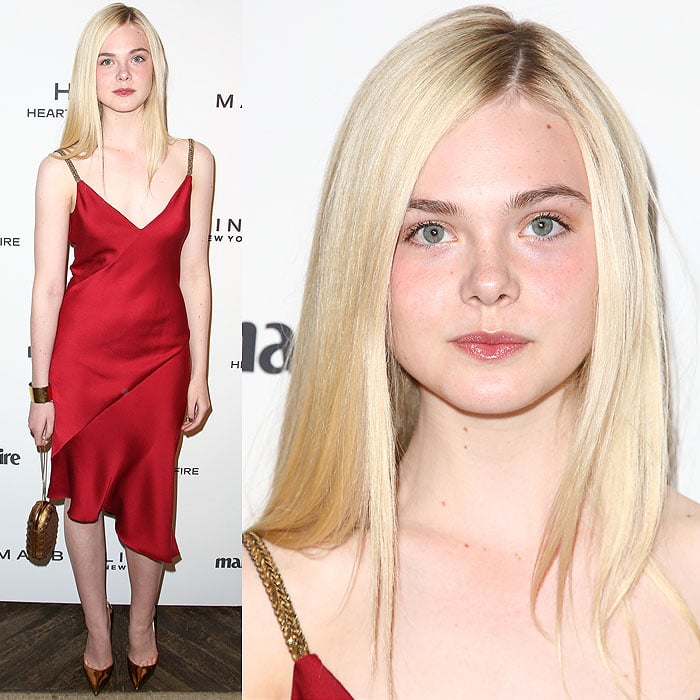 Elle Fanning dazzles in a ruby red Versace satin dress, perfectly paired with bronze Christian Louboutin "So Kate" pumps for a striking, elegant look