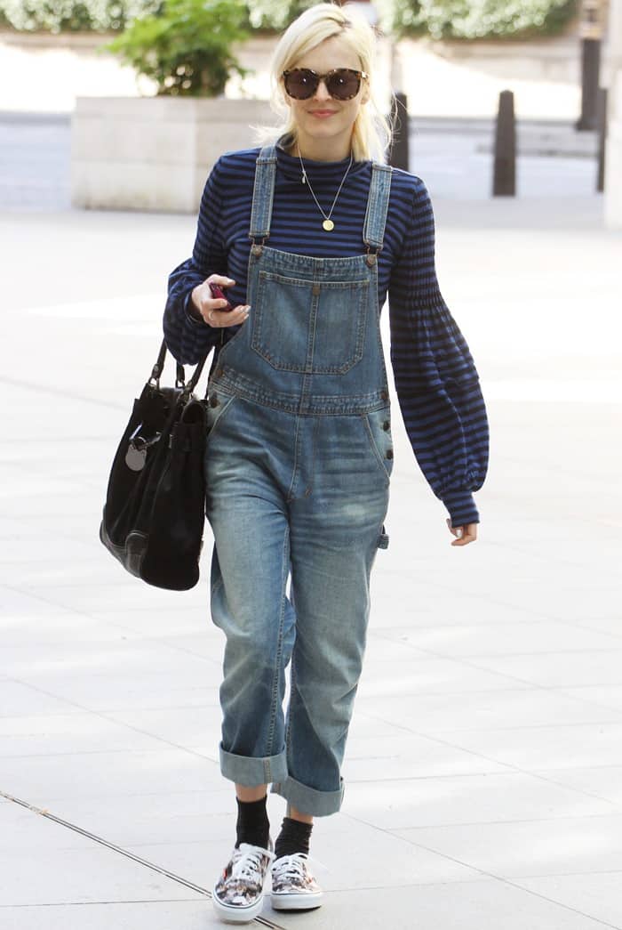 Fearne Cotton wears cuffed denim overalls over a striped sweater during her walk to work