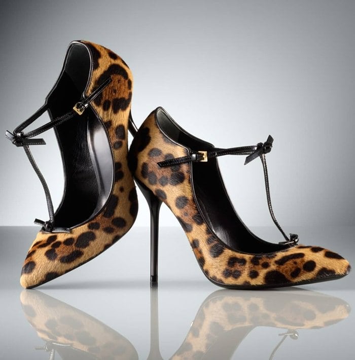 Trim twists detail the patent-leather T-strap of a leopard-patterned pump crafted from lush calf hair with a polished Gucci logo plate under the arch