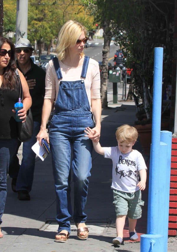 January Jones wearing denim overalls and tortoiseshell sunglasses, enjoying a day out with her son Xander Dane Jones in a Beatles T-shirt