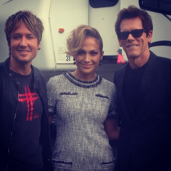 Jennifer Lopez wears her hair up while posing for a photo with Kevin Bacon and Keith Urban