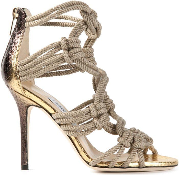 An iridescent finish illuminates the snake-stamped leather of a head-turning sandal with intricately knotted straps