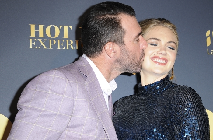 Justin Verlander kisses his wife Kate Upton at the Maxim Hot 100 Experience