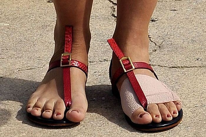 Maggie Gyllenhaal's bandaged left foot in red buckled Chloé sandals