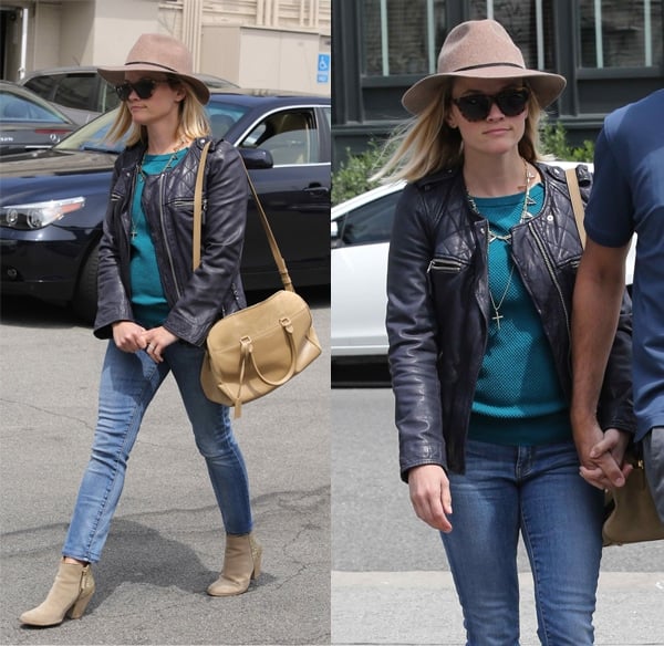 Reese Witherspoon wears a leather jacket with jeans