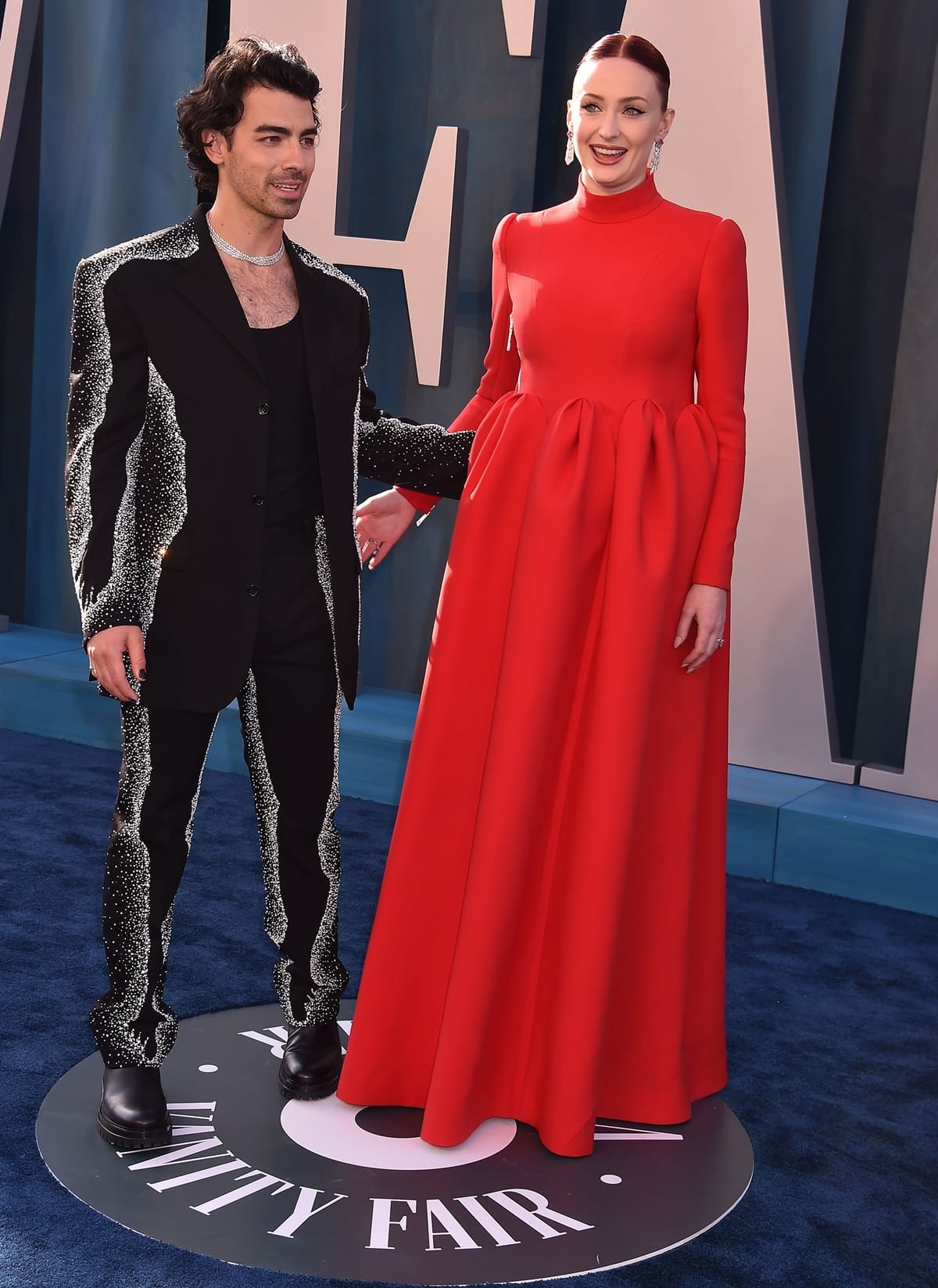 Sophie Turner in a red dress and Joe Jonas in a wool suit at the 2022 Vanity Fair Oscar Party