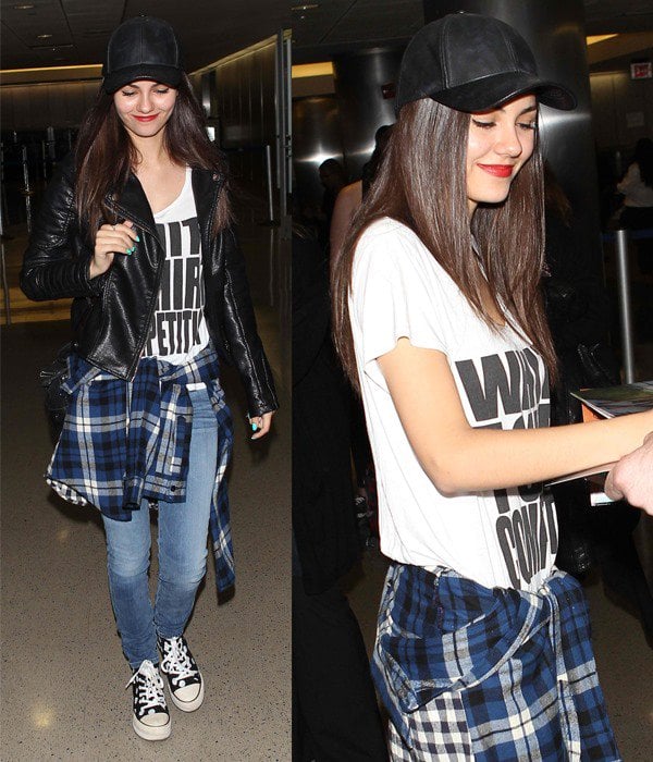 Victoria Justice wearing a white graphic tee, plaid shirt tied around her waist, leather jacket, and Converse platform sneakers at LAX