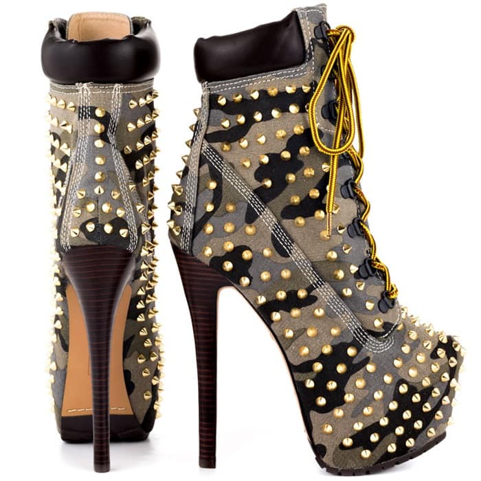 Spiky studs pepper a padded-collar boot perched atop a slim, stacked heel and covered platform