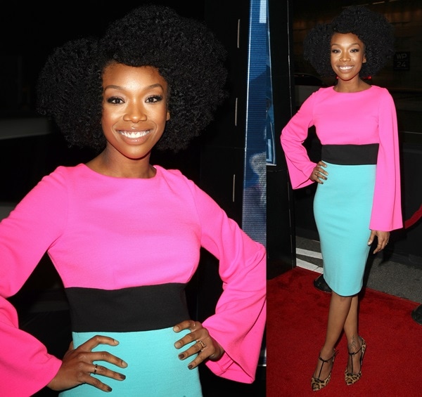 Brandy Norwood stuns in a bold color-blocked ensemble, pairing a bright pink and aqua dress with fierce animal-print heels