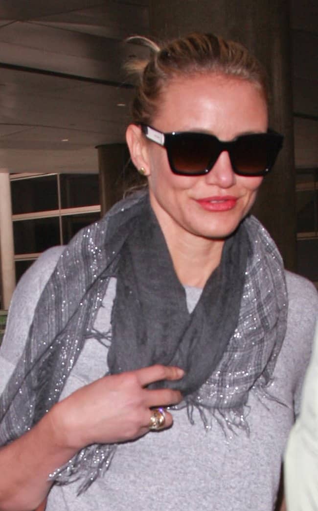 Cameron Diaz accessorizes her casual airport outfit with a stylish metallic scarf and oversized sunglasses at LAX