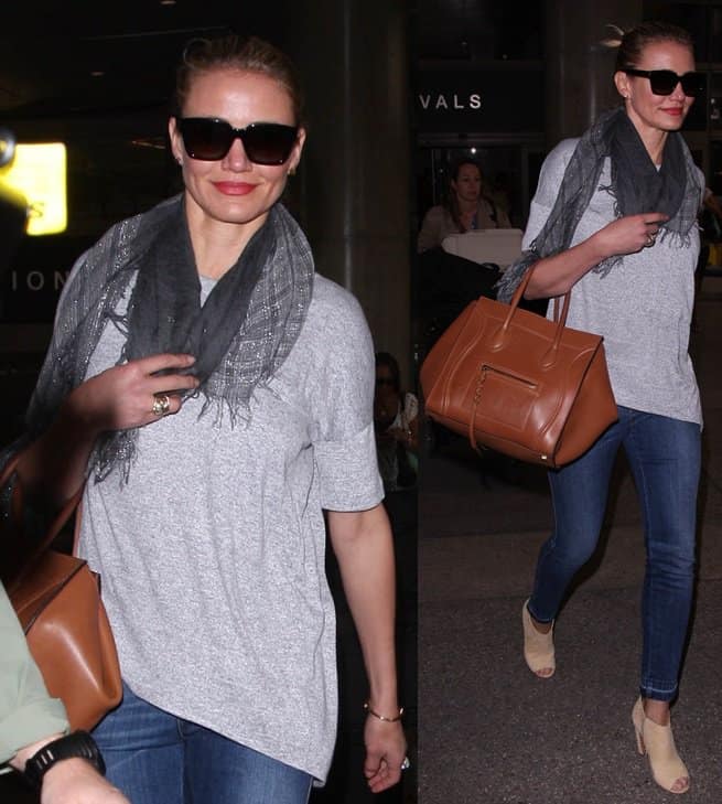 Cameron Diaz showcases her chic airport style with a grey t-shirt, denim jeans, metallic scarf, and a cognac-colored tote at LAX