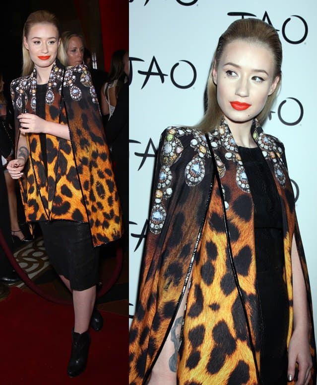 Iggy Azalea wears a black snakeskin leather sheath dress with a leopard print cape and black ankle boots