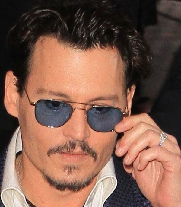 Johnny Depp styled his Tom Ford suit with blue-tinted glasses
