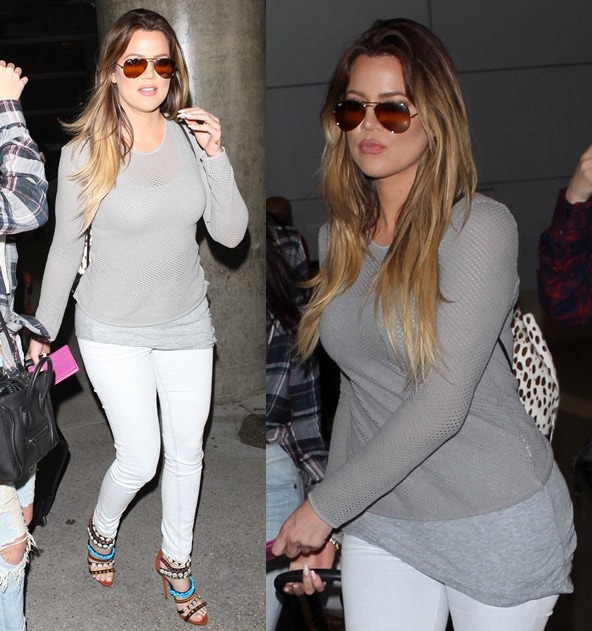 Khloe Kardashian keeps her hair down as she arrives at the Los Angeles International Airport with her family