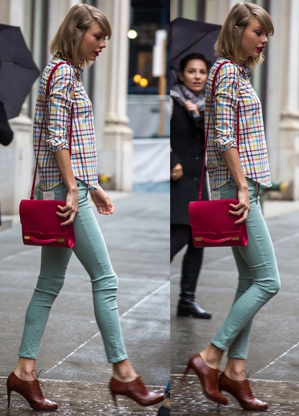 Taylor Swift wearing a retro outfit with a colorful checkered shirt, pastel green skinny jeans, brown heeled lace-up shoes, and a bright red clutch